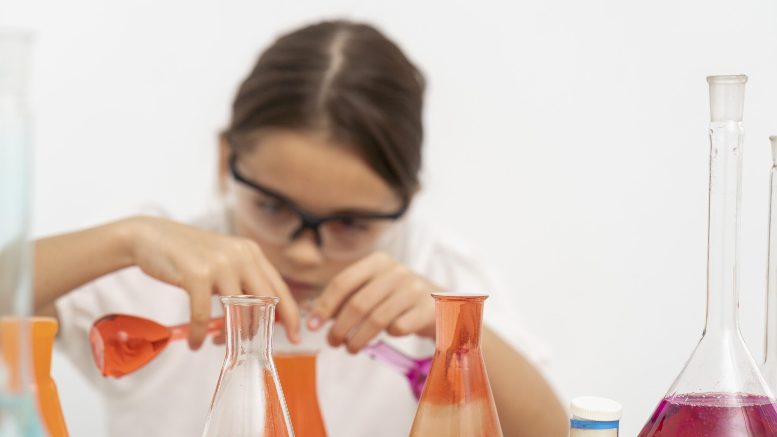 girl-with-safety-glasses-doing-chemistry-experiments